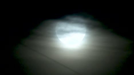 full moon through the clouds at night