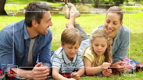 family lying on grass, enjoying nature with camera focus animation over them