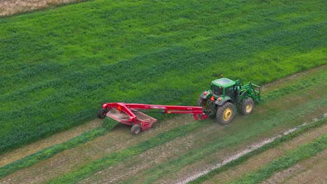 farmers' precision: aerial overlook of a green tractor on a circular field in british columbia