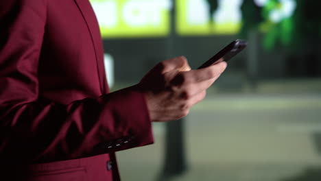 person checking messages on night walk