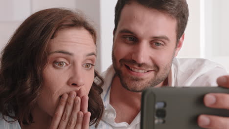 pareja feliz teniendo video chat usando un teléfono inteligente hablando con un amigo mirando sorprendido disfrutando de la comunicación en línea en el teléfono móvil