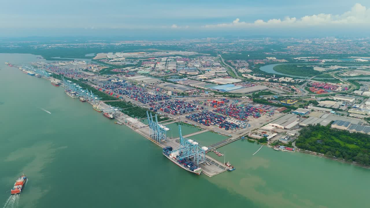 Aerial: Royal City of Klang Port during the day with cityscape in the state of Selangor, Malaysia, establishing a drone shot