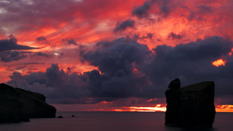 colorful sunset with red sky and sea view at the coastline of azores