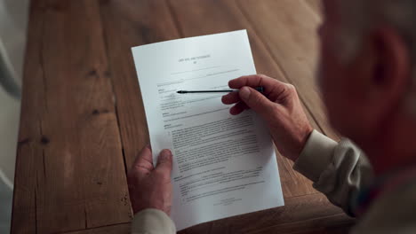 man reviewing last will and testament document