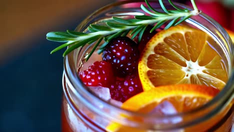 refreshing iced berry and citrus drink in mason jar