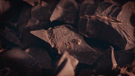 Chunks-of-sweet-dark-chocolate-sliding-backdrop,-close-up