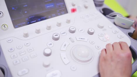 doctor working at ultrasound diagnostic machine. doctor hand doing medical examination of patient with ultrasound scanner machine