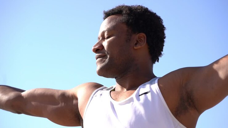Happy african american man training at sunny day