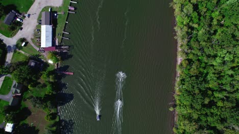 top view over two jet skis passing in the fox river next to an small dock, crystal lake, illinois