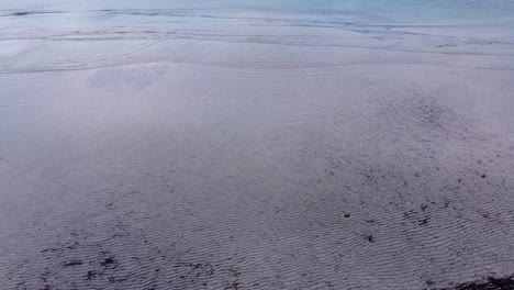 Aerial-View-Over-Clear-Calm-Shallow-Waters-And-Ripples-In-Sand