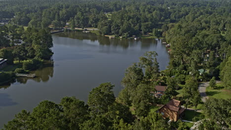 Jackson-Georgia-Aerial-v4-drone-flying-along-shimmering-high-falls-lake-toward-downstream-towaliga-river,-surrounded-by-evergreen-forest---Shot-with-Inspire-2,-X7-camera---September-2020