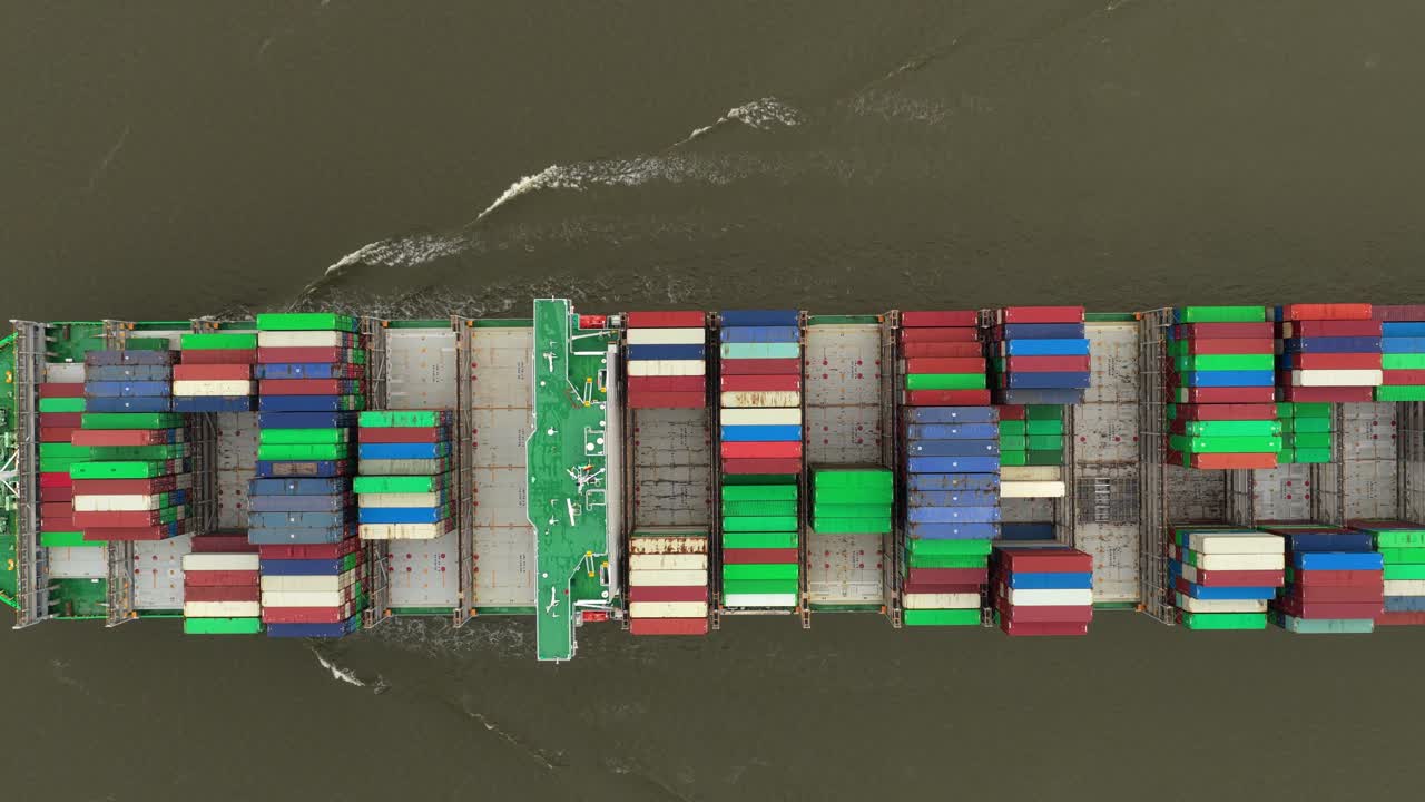 Shipping vessels move containers along Elbe River in global commerce