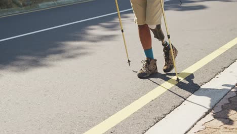 sporty mixed race man with prosthetic leg hiking