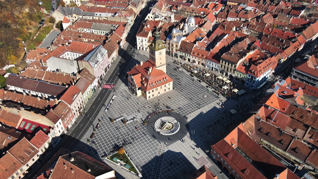 Aerial drone view of The Council Square in Brasov, Romania. Old city centre with County Museum of History, buildings, people