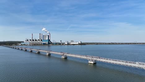 Konin-Poland-aerial-view-of-old-coal-power-plant-drone-fly-above-bridge-connecting-warta-river