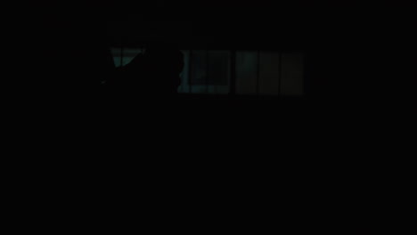 person in wheelchair in dark industrial setting