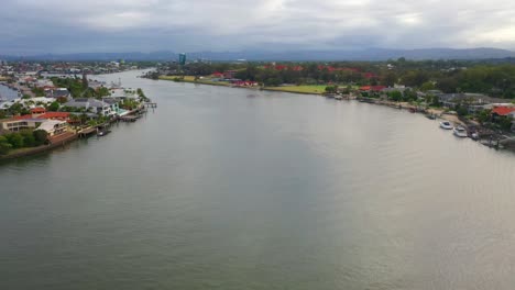 Peaefully-flying-down-main-canal-on-a-cloudy-day,-Surfers-Paradise-Queensland-Austrlia