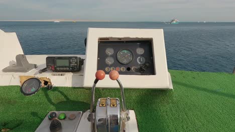 steering wheel and navigation compass on a yacht background of red sea