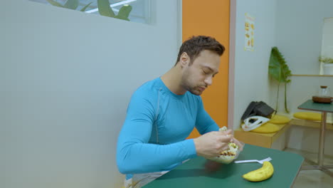 happy fit man enjoy fresh salad after exercise