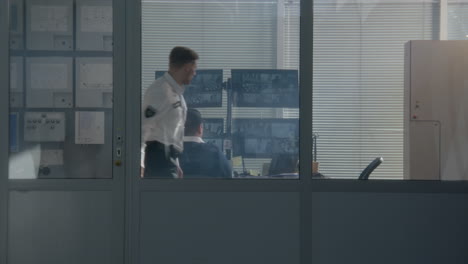security personnel monitoring surveillance system in a control room