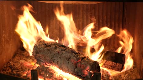 a fire is burning in the home fireplace.