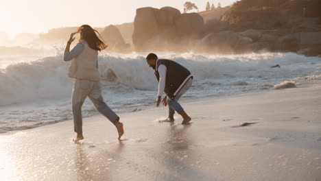 couple, running and sunset splash at a beach