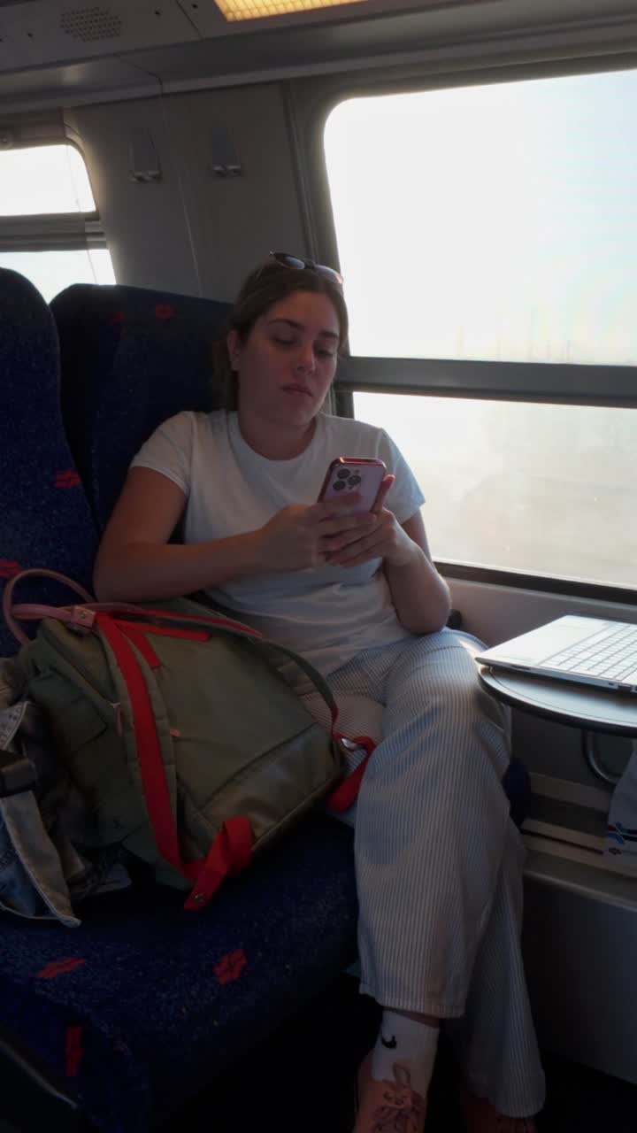 Passenger Enjoying Her Mobile Device on Public Transportation