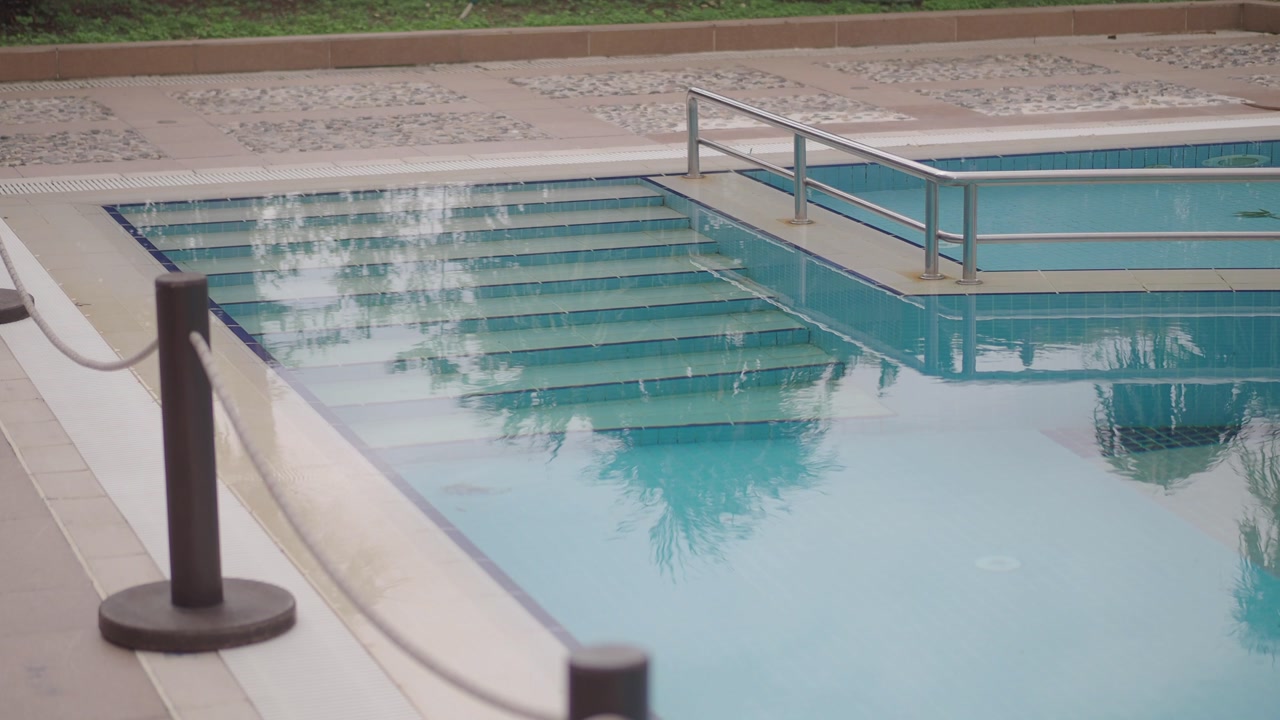 Serene Outdoor Swimming Pool with Clear Water and Reflections