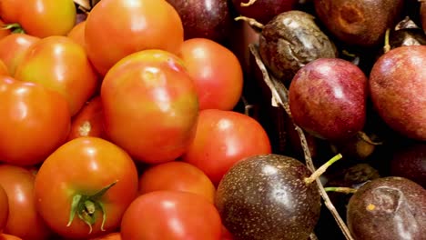 a vibrant arrangement of ripe passion fruits and tomatoes showcasing freshness and color.