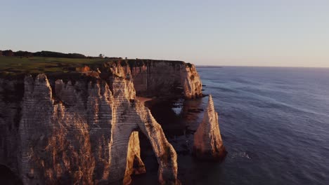 sunrise over the iconic chalk cliffs of étretat, france