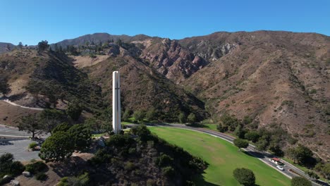 the phillips theme tower at pepperdine university with the surrounding mountains and canyons in the background - aerial flyover