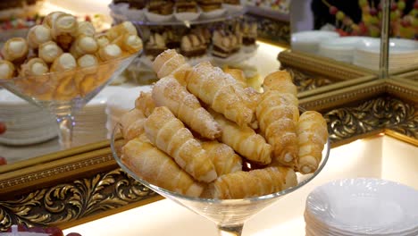 sweet pastry tubes filled with whipped cream arranged on an elegant table