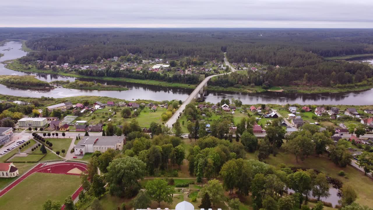 Aerial view of Kraslava Manor with River Daugava and bridge in the background, dolly in shot