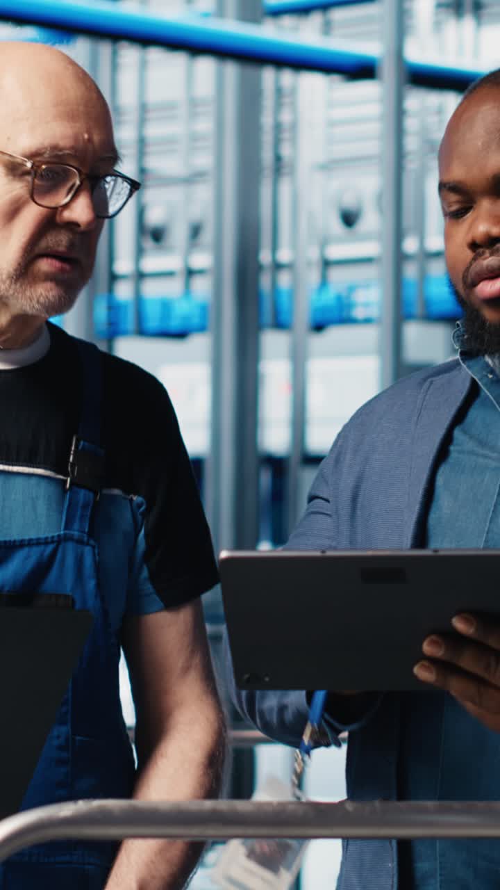 Vertical video Manager overseeing smart factory, giving instructions to engineers