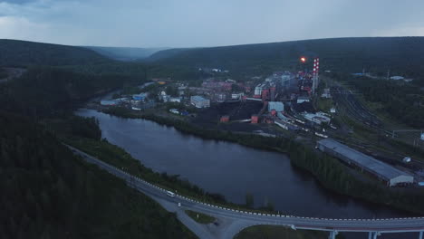 industrial complex by the river at dusk