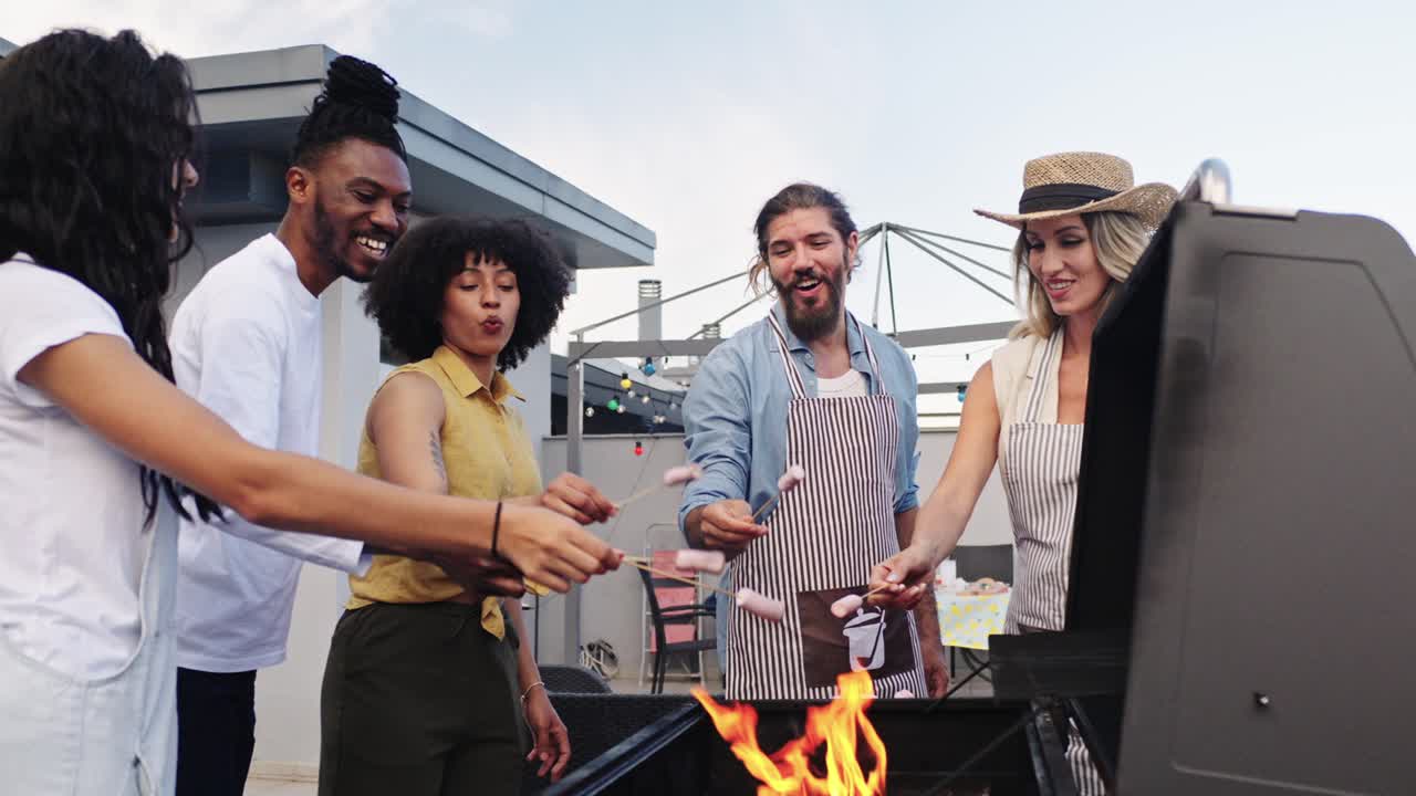 Friends grilling sausages at a rooftop barbecue party
