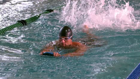 fit muscular swimmer swimming in the pool