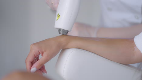 close-up. laser hair removal under the armpit of a beautiful girl in a beauty salon. woman having underarm laser hair removal epilation. laser treatment in cosmetic salon