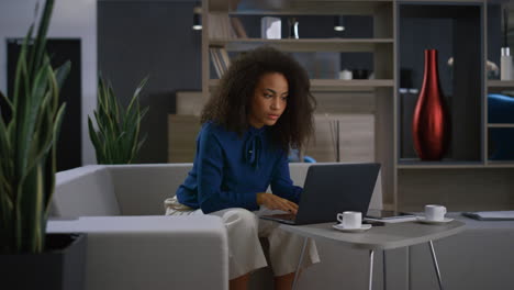 busy african american businesswoman typing laptop keyboard drink coffee on work.