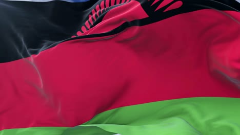 flag of malawi waving at wind with blue sky in slow, loop