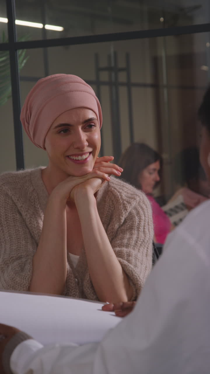 Vertical Video Of Young Woman Patient Wearing Headscarf Undergoing Chemotherapy Treatment For Breast Cancer Meeting With Oncologist Or Doctor In Hospital 2