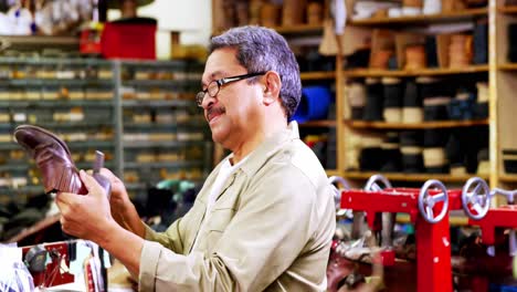 Cobbler-examining-a-shoe