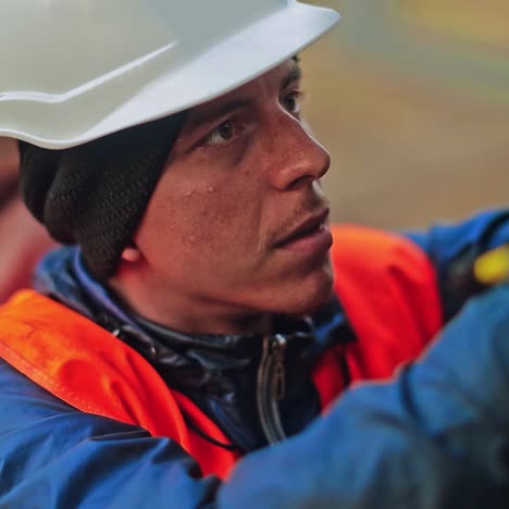 operation and maintenance in solar power plant. worker in protective uniform with hard hat checking the electricity system.