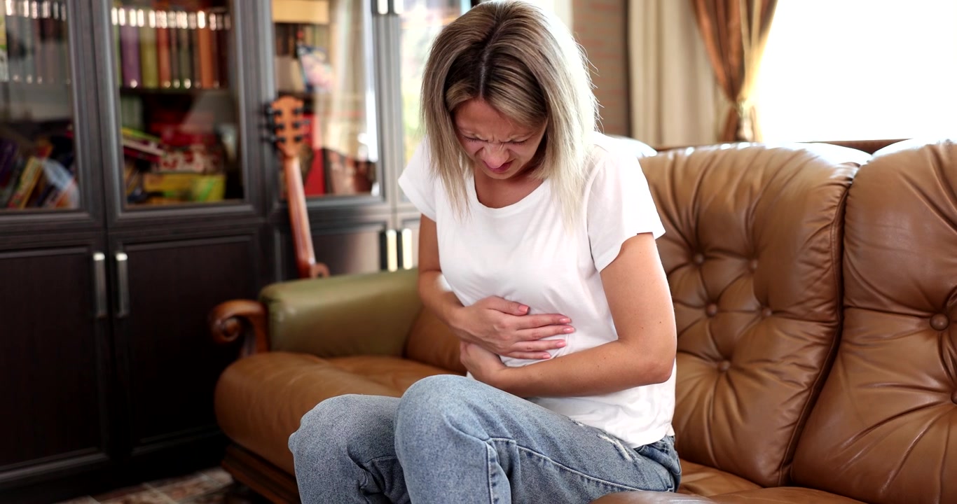 Struggling with discomfort at home during a quiet afternoon