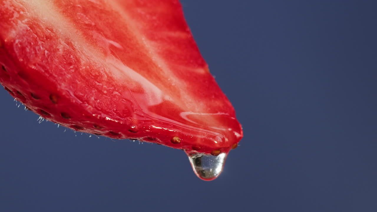 Close-up of a strawberry slice with a water drop