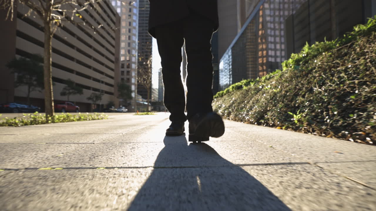 Person Walking Down City Street at Sunset