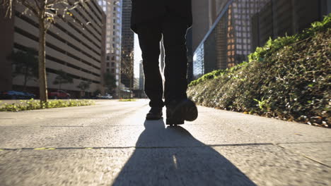 person walking down city street at sunset