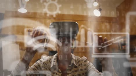 multiple digital icons and binary coding against woman wearing a vr headset at office