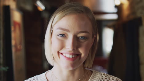 Head-And-Shoulders-Portrait-Of-Attractive-Smiling-Woman-Inside-Hotel