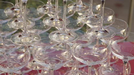 stacked wine glasses on red table. banquet preparation setup